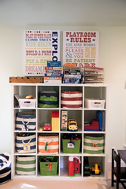 cubicle shelving holding colorful baskets and various toys